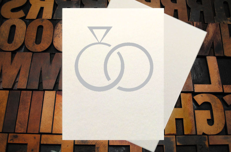 Letterpress Card with the text, "I -heart shape- you more than bacon" over an image of a strip of bacon