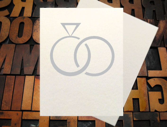 Letterpress Card with the text, "I -heart shape- you more than bacon" over an image of a strip of bacon