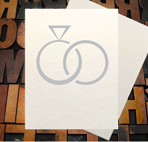 Letterpress Card with the text, "I -heart shape- you more than bacon" over an image of a strip of bacon