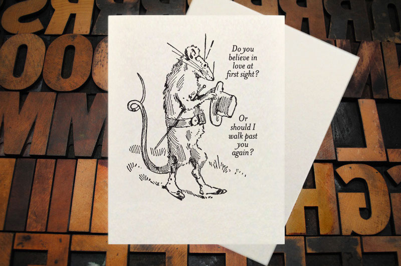 Letterpress Card with the text, "I -heart shape- you more than bacon" over an image of a strip of bacon