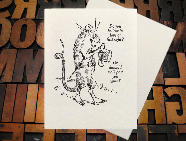 Letterpress Card with the text, "I -heart shape- you more than bacon" over an image of a strip of bacon