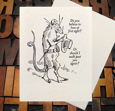 Letterpress Card with the text, "I -heart shape- you more than bacon" over an image of a strip of bacon