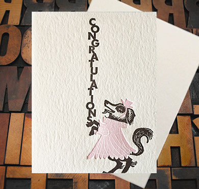Letterpress Card with an image of a dog in a pink dress with the text, "Congratulations!"