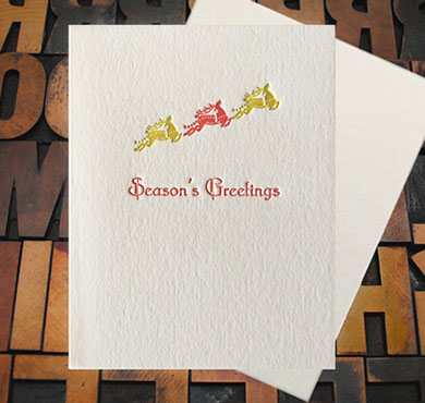Letterpress Card with the text, "Seasons Greetings" and three flying reindeer