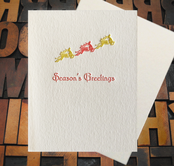 Letterpress Card with the text, "Seasons Greetings" and three flying reindeer