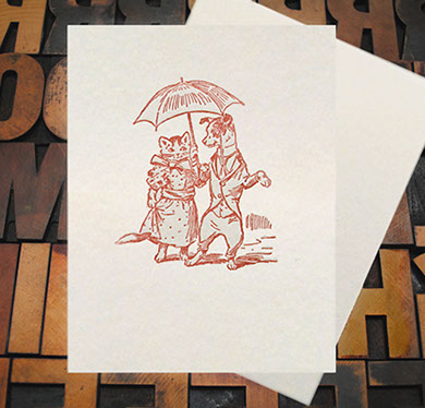Letterpress Card with an image of a dog and cat holding an umbrella while wearing clothes