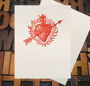Letterpress Card with an image of a bleeding heart, with arrow, cross, and flames