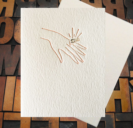 Letterpress Card with an image of a woman's hand bearing an engagement ring that features a real rhinestone
