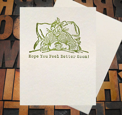 Letterpress Card with an image of a sick man in bed with the text, "Hope you feel better soon!"