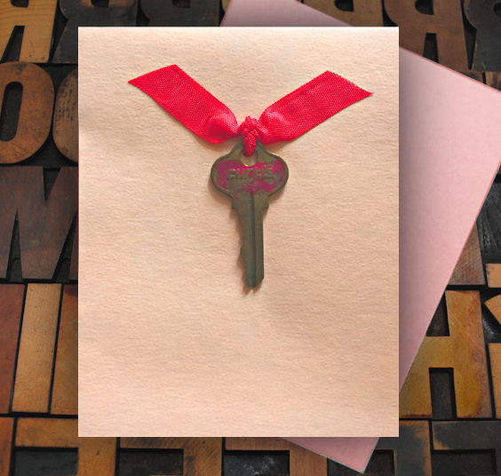 Card with vintage key tied with ribbon