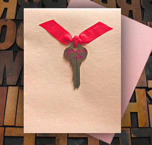 Card with vintage key tied with ribbon