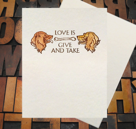 Letterpress Card with an image of two dogs sharing a bone with the text, "Love is give and take."