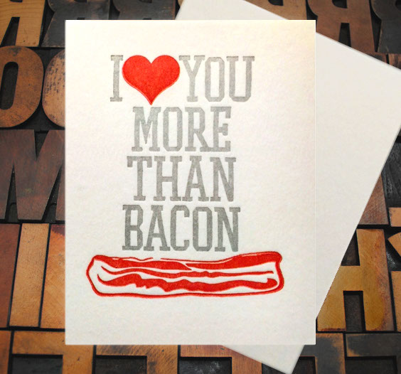 Letterpress Card with the text, "I -heart shape- you more than bacon" over an image of a strip of bacon