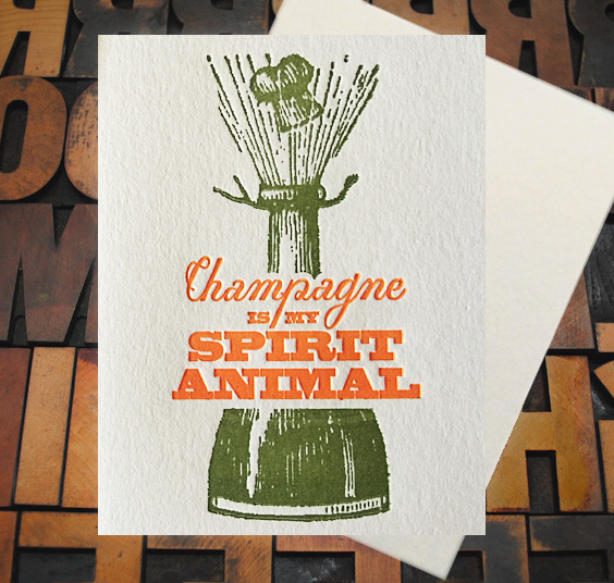 Letterpress Card with a bottle of champagne popping and the text, "Champagne is my spirit animal"