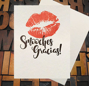 Letterpress Card with an image of lip imprints over top of the text, "Smooches Gracias!"