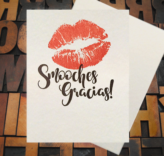 Letterpress Card with an image of lip imprints over top of the text, "Smooches Gracias!"