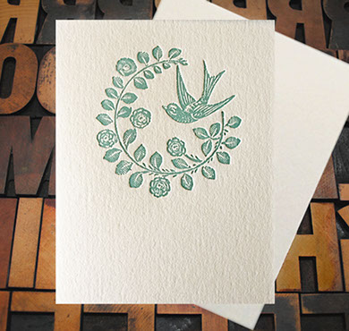 Letterpress Card with an image of a swallow and a floral laurel
