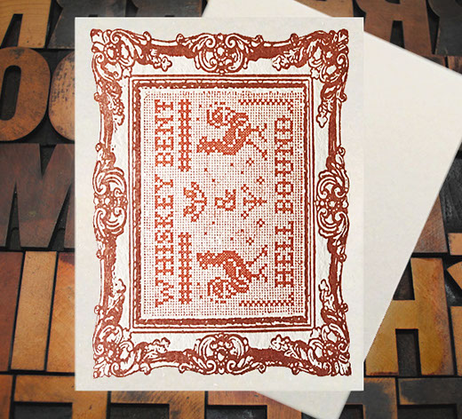 Letterpress Card with cross-stitched image of the text "Whiskey Bent and Hell Bound" with roosters and a frame