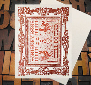 Letterpress Card with cross-stitched image of the text "Whiskey Bent and Hell Bound" with roosters and a frame