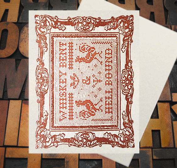 Letterpress Card with cross-stitched image of the text "Whiskey Bent and Hell Bound" with roosters and a frame